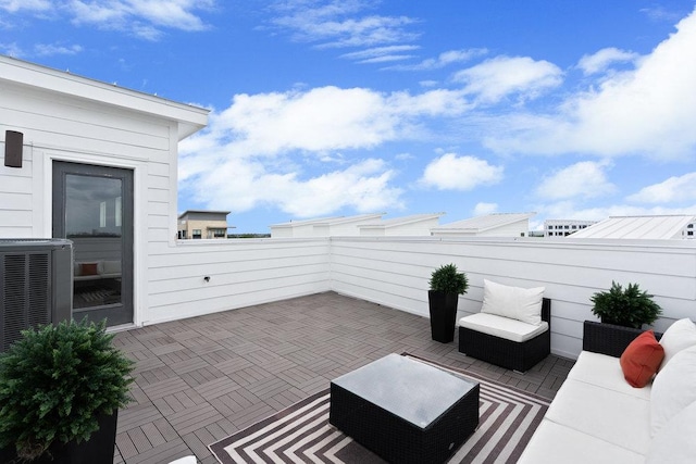 view of patio with cooling unit and a balcony