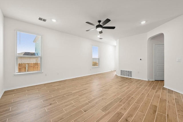12106 Cantabria Rd, Austin, TX 78748 - empty room with arched walkways, light wood finished floors, ceiling fan, and recessed lighting