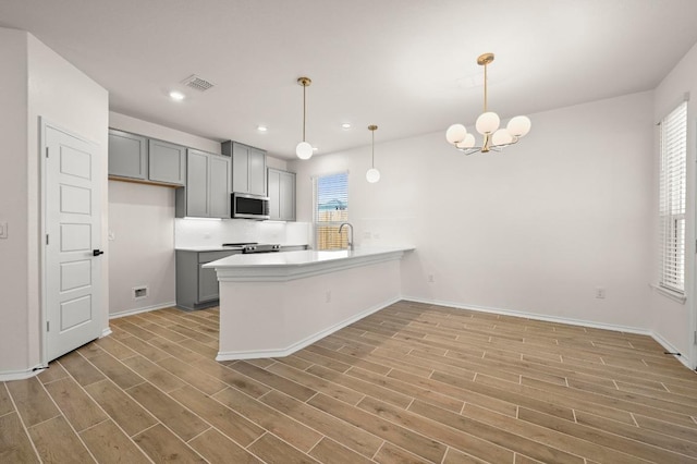 12106 Cantabria Rd, Austin, TX 78748 - kitchen featuring appliances with stainless steel finishes, gray cabinets, light wood-style floors, and recessed lighting