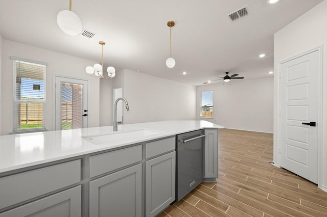 12106 Cantabria Rd, Austin, TX 78748 - kitchen with dishwasher, light wood finished floors, decorative light fixtures, light countertops, and recessed lighting