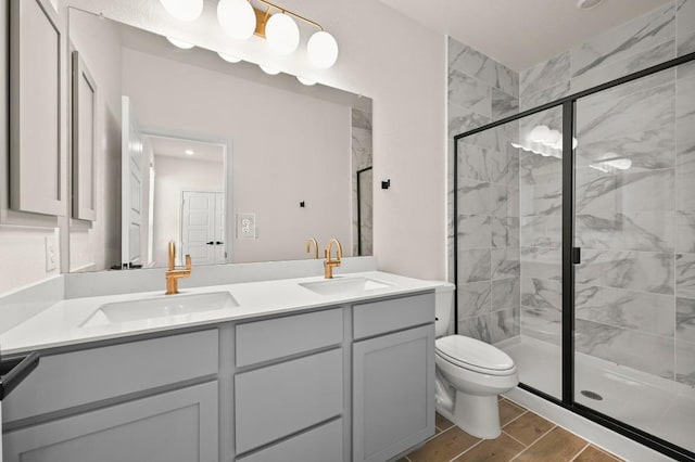 12106 Cantabria Rd, Austin, TX 78748 - bathroom with double vanity, a shower stall, and wood finished floors