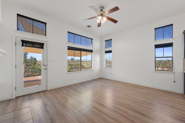 7313 Rimcrest Cv Unit A2, Austin, TX 78735 - spare room featuring wood finished floors, plenty of natural light, and ceiling fan