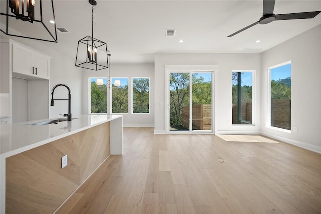 6301 Bristol Cir Unit 2, Austin, TX 78723 - kitchen with a chandelier, a sink, baseboards, light wood finished floors, and recessed lighting