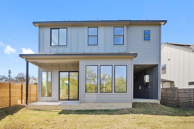 6301 Bristol Cir Unit 2, Austin, TX 78723 - back of property featuring board and batten siding, water heater, and a patio area
