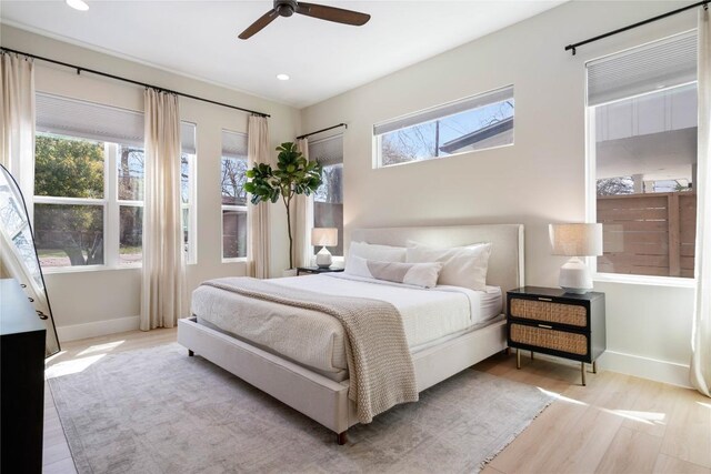 1126 Linden St Unit 1, Austin, TX 78702 - bedroom featuring light wood finished floors, multiple windows, baseboards, recessed lighting, and ceiling fan