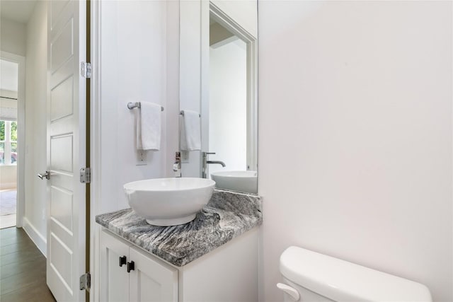 1126 Linden St Unit 1, Austin, TX 78702 - half bathroom with toilet, vanity, and wood finished floors