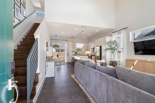 1126 Linden St Unit 1, Austin, TX 78702 - living room featuring a high ceiling, stairway, and recessed lighting