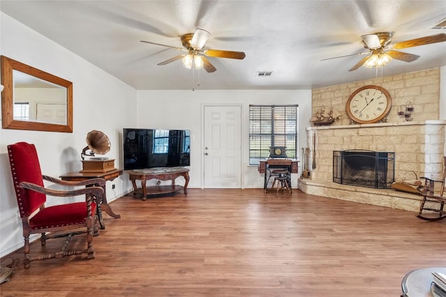 491 Herron Trl, Mcdade, TX 78650 - living area with ceiling fan, wood finished floors, a fireplace, and baseboards