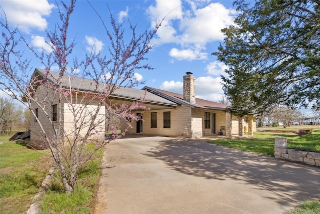 491 Herron Trl, Mcdade, TX 78650 - ranch-style house featuring driveway, a chimney, a front lawn, and stone siding