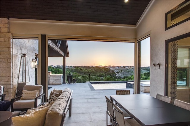 patio terrace at dusk featuring an outdoor living space and outdoor dining space