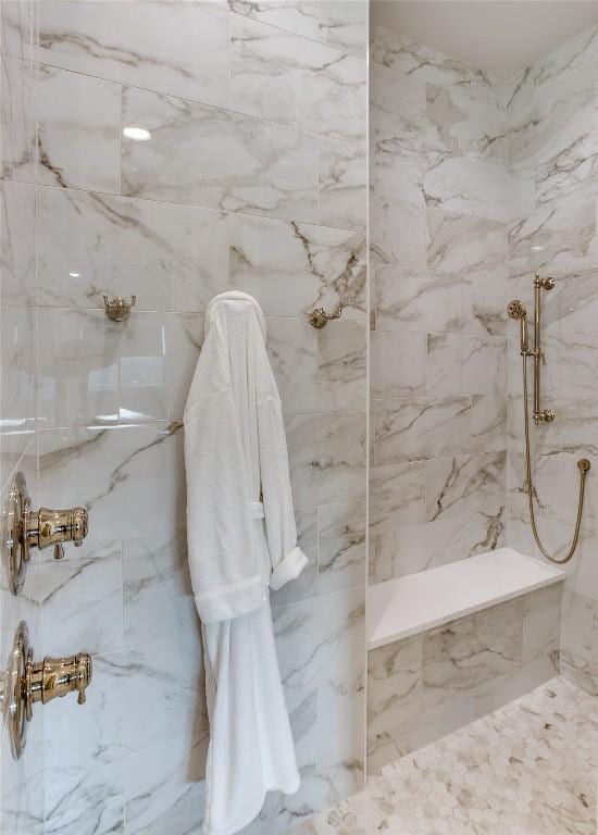 bathroom with a marble finish shower