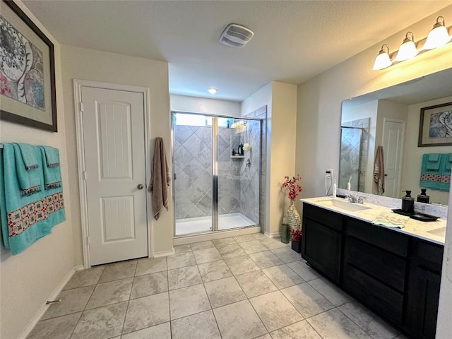 1208 Ravenside Cv, Leander, TX 78641 - bathroom with double vanity, a stall shower, and tile patterned floors