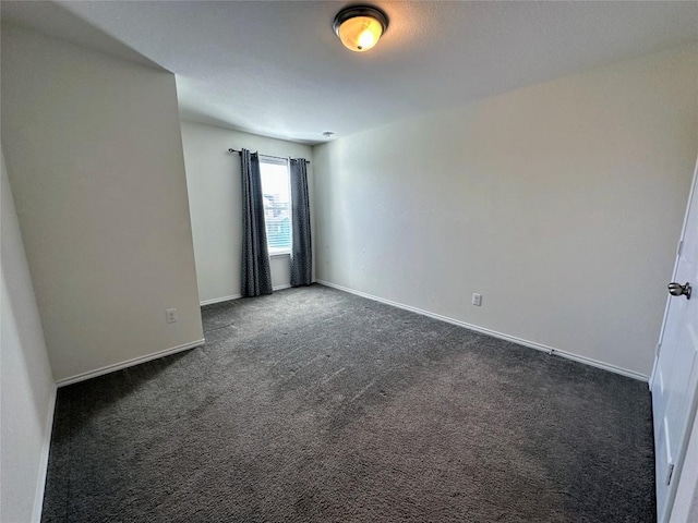 1208 Ravenside Cv, Leander, TX 78641 - spare room featuring dark carpet and baseboards