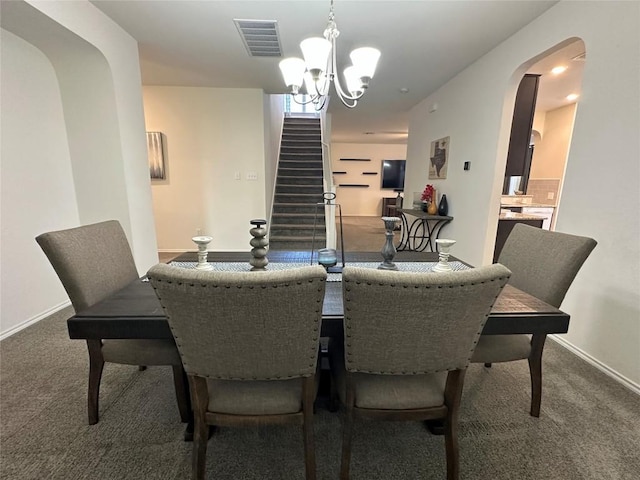 1208 Ravenside Cv, Leander, TX 78641 - dining area featuring carpet, a chandelier, stairs, and arched walkways