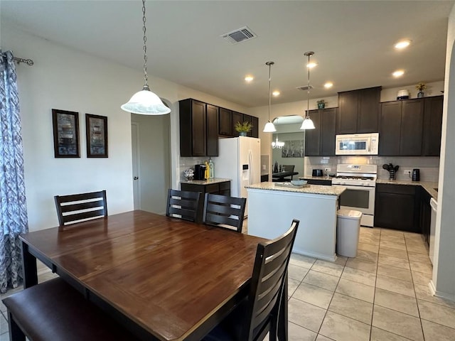 1208 Ravenside Cv, Leander, TX 78641 - dining room with light tile patterned floors and recessed lighting