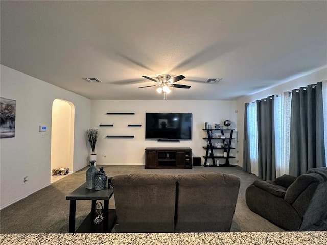 1208 Ravenside Cv, Leander, TX 78641 - living room featuring arched walkways, carpet, and a ceiling fan