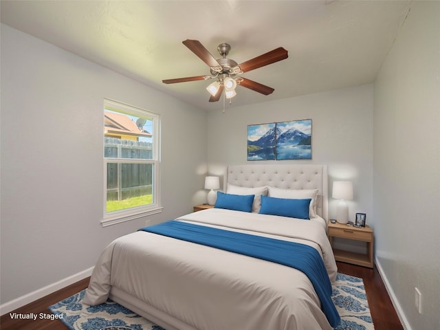 bedroom with baseboards, ceiling fan, and wood finished floors