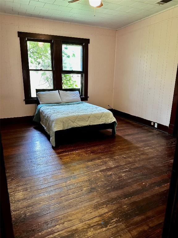 1106 Lexington St, Taylor, TX 76574 - bedroom with dark wood finished floors and baseboards
