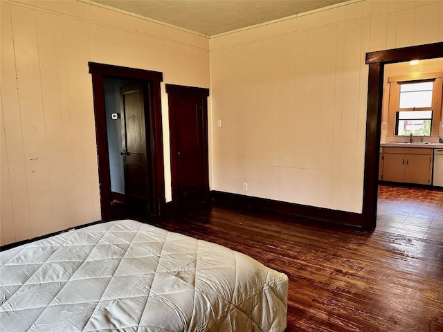 1106 Lexington St, Taylor, TX 76574 - bedroom with a sink, ornamental molding, hardwood / wood-style flooring, and baseboards