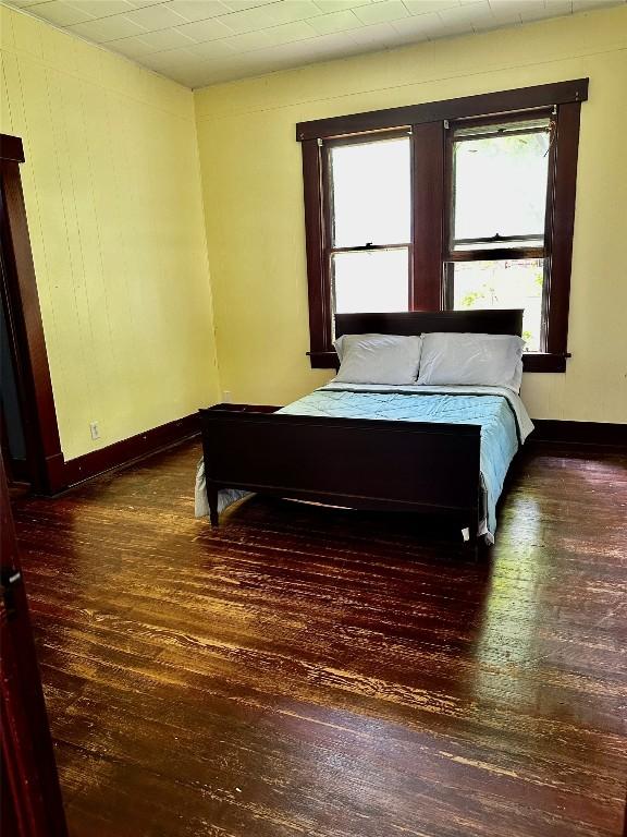 1106 Lexington St, Taylor, TX 76574 - bedroom featuring baseboards and hardwood / wood-style flooring