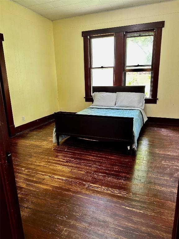 1106 Lexington St, Taylor, TX 76574 - bedroom with baseboards and wood-type flooring