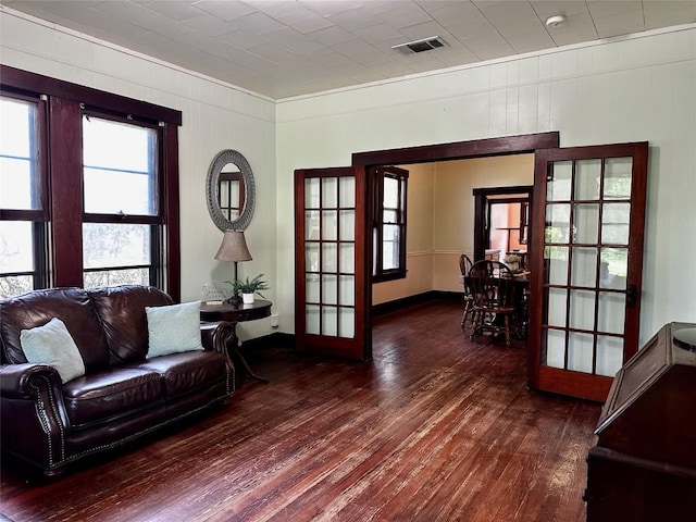1106 Lexington St, Taylor, TX 76574 - living room with ornamental molding, french doors, visible vents, and wood finished floors