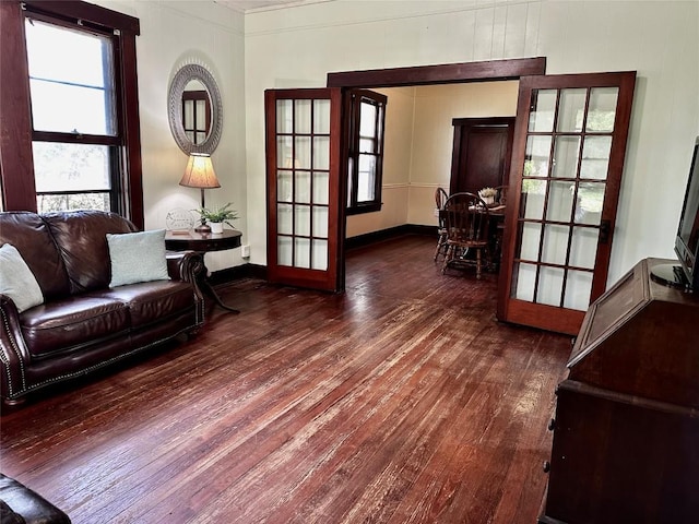1106 Lexington St, Taylor, TX 76574 - living area featuring crown molding, french doors, baseboards, and wood-type flooring