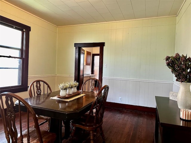 1106 Lexington St, Taylor, TX 76574 - dining space with baseboards, ornamental molding, and dark wood-style floors