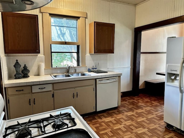 1106 Lexington St, Taylor, TX 76574 - kitchen featuring a sink, decorative backsplash, white appliances, and tile countertops