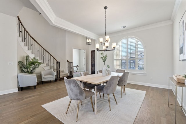 4709 Napoli Shore Dr, Leander, TX 78641 - dining area with a chandelier, ornamental molding, stairs, and wood finished floors