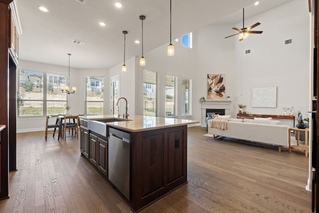 4709 Napoli Shore Dr, Leander, TX 78641 - kitchen featuring stainless steel dishwasher, ceiling fan, dark wood-style flooring, recessed lighting, and dark brown cabinets