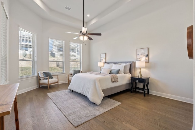 4709 Napoli Shore Dr, Leander, TX 78641 - bedroom featuring wood finished floors, a tray ceiling, and ceiling fan