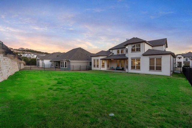 4709 Napoli Shore Dr, Leander, TX 78641 - back of house at dusk featuring a fenced backyard, a patio, and stucco siding