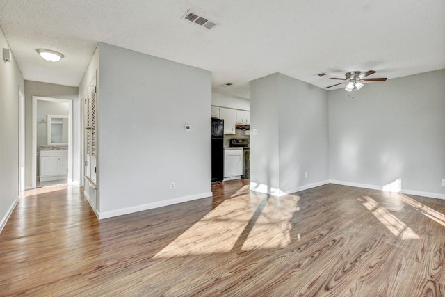 2712 Windswept Cv, Austin, TX 78745 - unfurnished living room with wood finished floors and a ceiling fan
