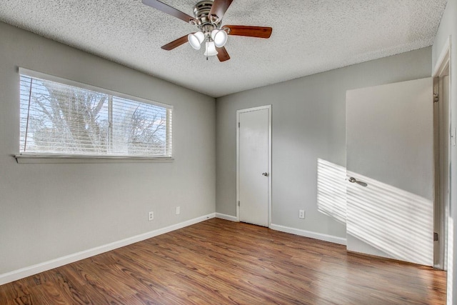 2712 Windswept Cv, Austin, TX 78745 - unfurnished bedroom with wood finished floors, a textured ceiling, and ceiling fan