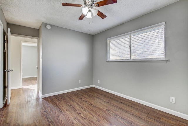 2712 Windswept Cv, Austin, TX 78745 - empty room featuring a textured ceiling, a ceiling fan, dark wood-type flooring, and a smoke detector