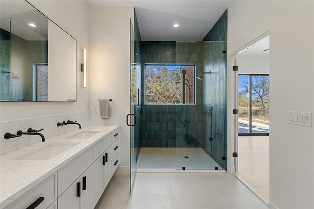 bathroom with recessed lighting, a sink, double vanity, and a stall shower