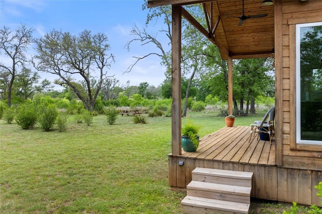 view of yard with a wooden deck and ceiling fan