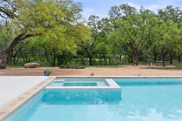 view of swimming pool featuring a pool with connected hot tub