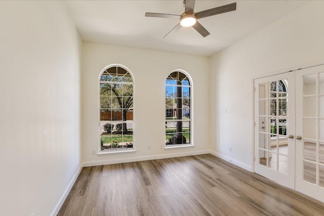 3905 Stonehenge Path, Round Rock, TX 78681 - unfurnished room featuring french doors, wood finished floors, a ceiling fan, and baseboards