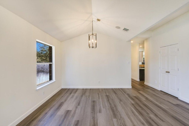 3905 Stonehenge Path, Round Rock, TX 78681 - unfurnished dining area featuring a chandelier, wood finished floors, and lofted ceiling