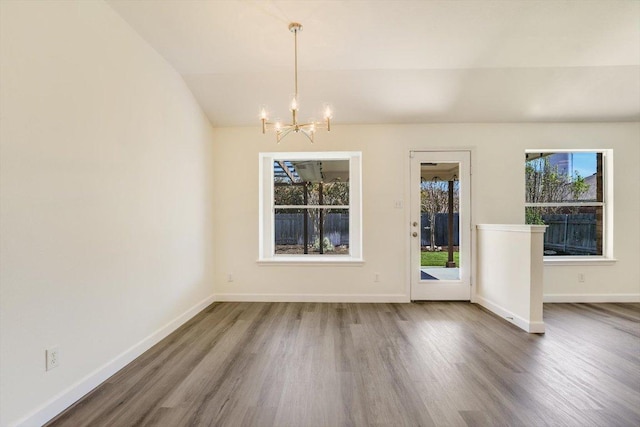 3905 Stonehenge Path, Round Rock, TX 78681 - unfurnished dining area with wood finished floors, a chandelier, lofted ceiling, and baseboards