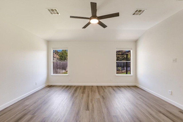 3905 Stonehenge Path, Round Rock, TX 78681 - empty room with healthy amount of natural light, wood finished floors, and a ceiling fan
