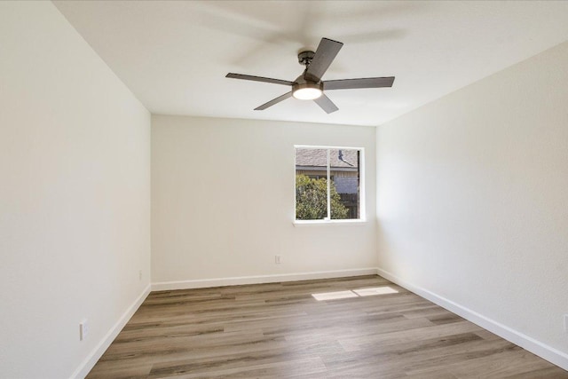 3905 Stonehenge Path, Round Rock, TX 78681 - spare room with wood finished floors, ceiling fan, and baseboards