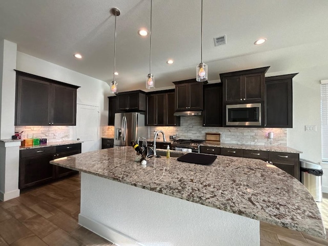 2905 Lago Costa Dr, La Marque, TX 77568 - kitchen with stainless steel appliances, tasteful backsplash, a large island, light stone counters, and under cabinet range hood