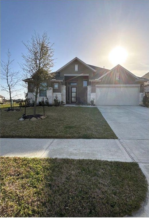 2905 Lago Costa Dr, La Marque, TX 77568 - view of front of home with driveway, a front yard, and a garage
