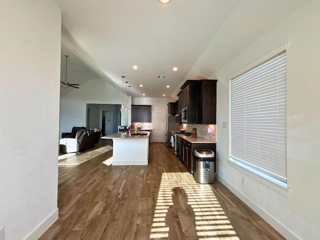 2905 Lago Costa Dr, La Marque, TX 77568 - kitchen featuring open floor plan, stainless steel appliances, dark wood-style flooring, recessed lighting, and lofted ceiling