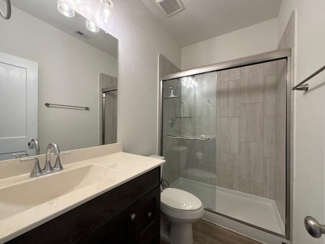 2905 Lago Costa Dr, La Marque, TX 77568 - bathroom featuring a stall shower, vanity, and wood finished floors
