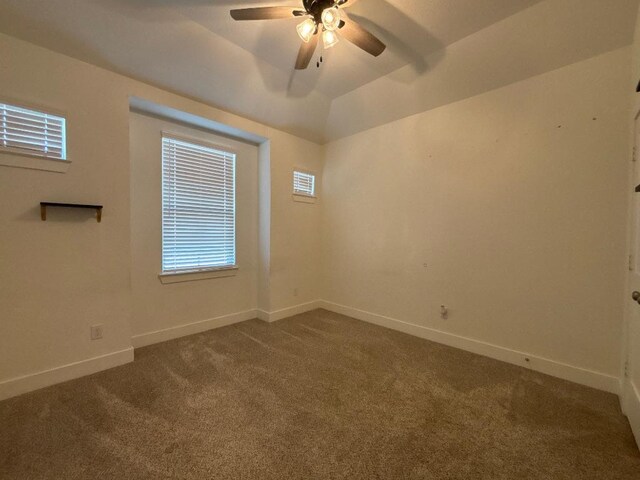 2905 Lago Costa Dr, La Marque, TX 77568 - empty room with baseboards, lofted ceiling, a ceiling fan, and dark carpet