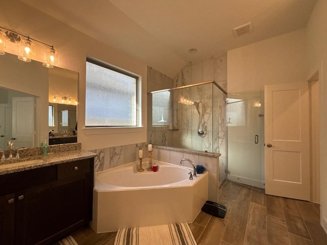 2905 Lago Costa Dr, La Marque, TX 77568 - full bathroom featuring a bath, visible vents, a shower stall, and vanity